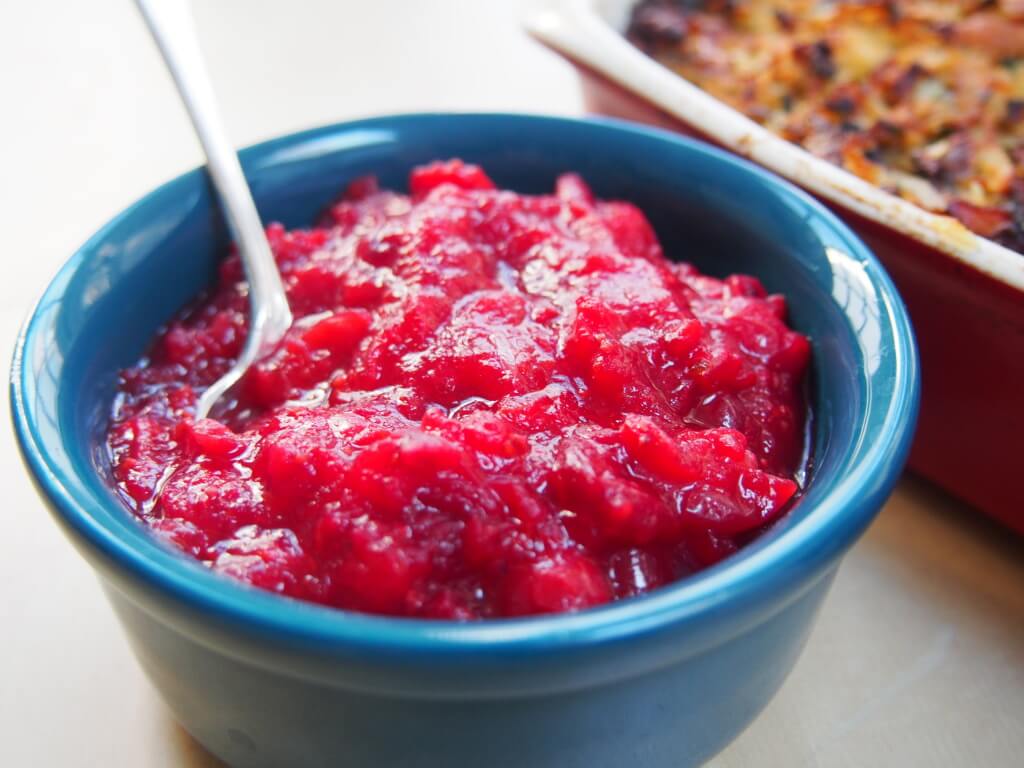 bowl of cranberry sauce with spoon in it