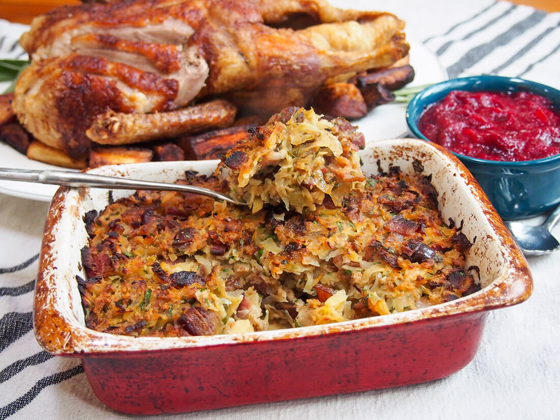 rutabaga, date and bacon stuffing with roasted duck and cranberry sauce behind
