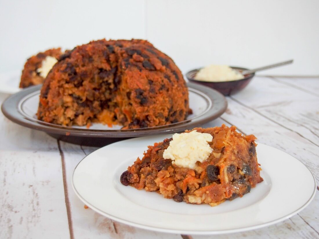 lighter Christmas pudding - slice on plate with rest behind