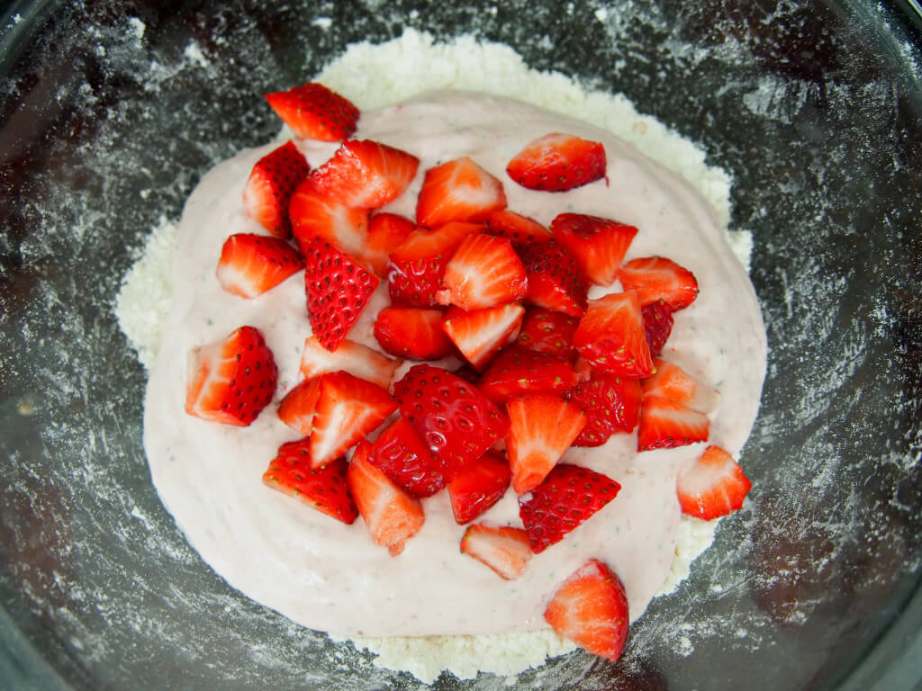 adding strawberries to make strawberry scones
