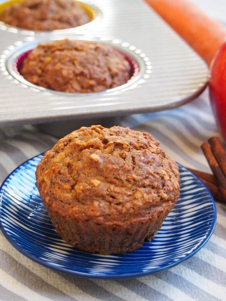 Healthy carrot apple muffins with one on small plate