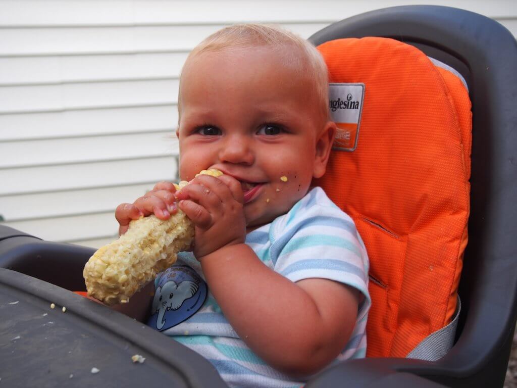 our youngest enjoying corn