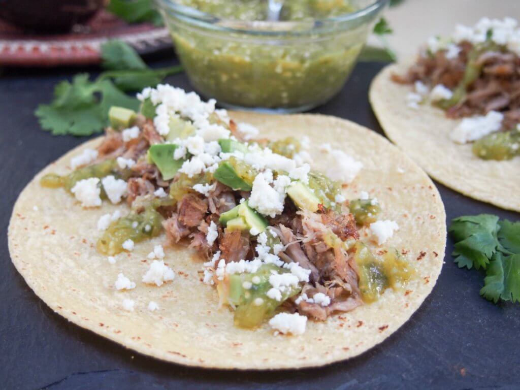 Pork carnitas tacos with tomatillo salsa verde - delicious slow cooker pork, a quick & easy salsa and all with so much flavor.
