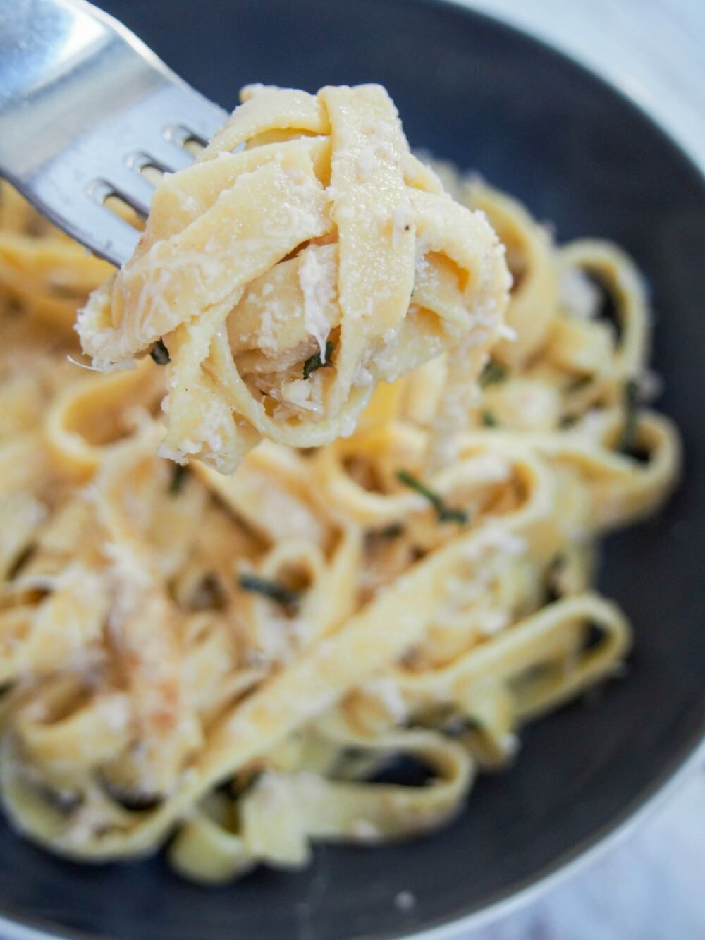 pasta on fork above bowl 