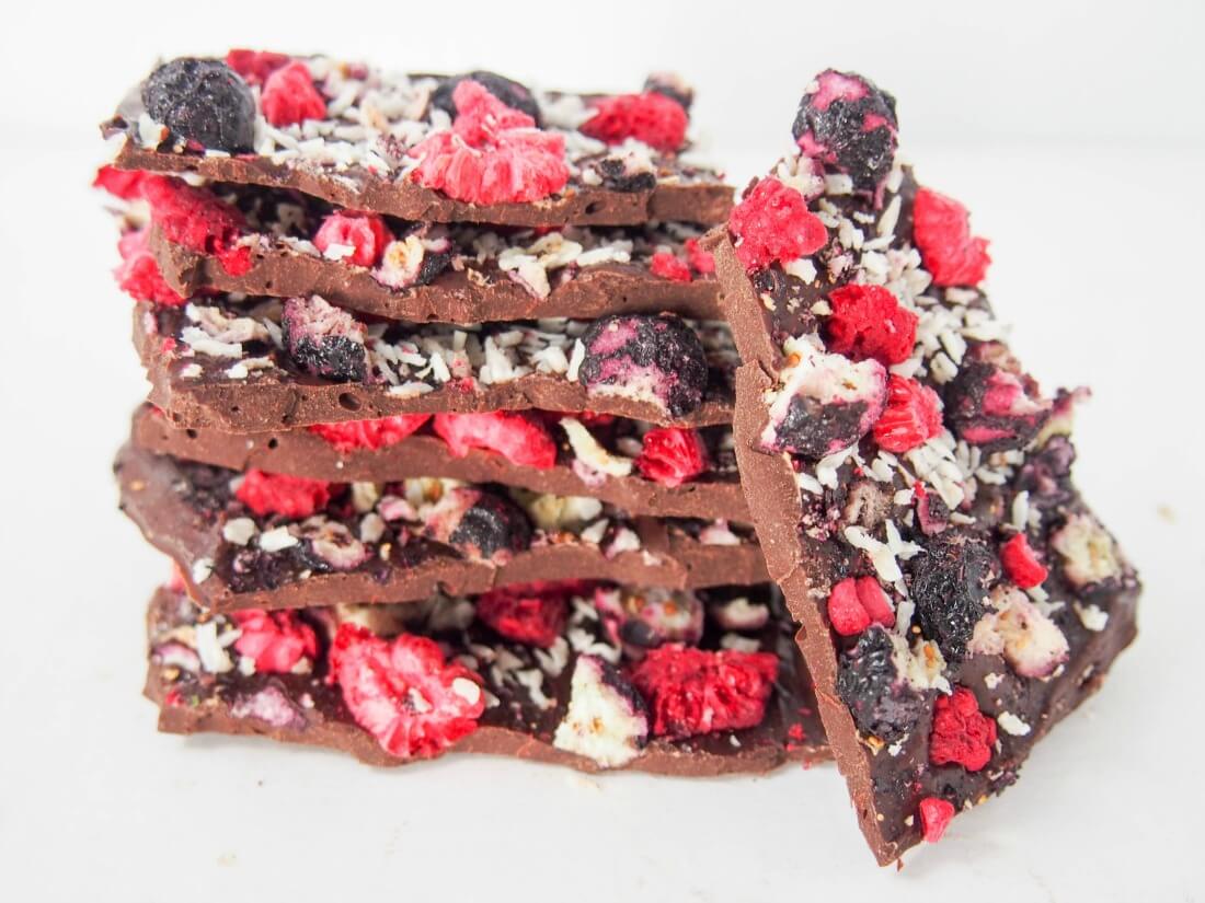 blueberry raspberry chocolate bark in stack with one piece resting on side