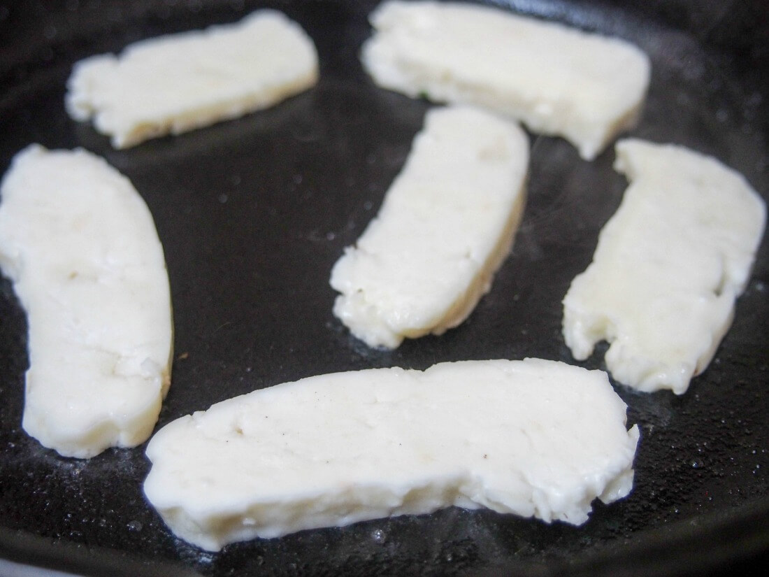 cooking halloumi slices in skillet