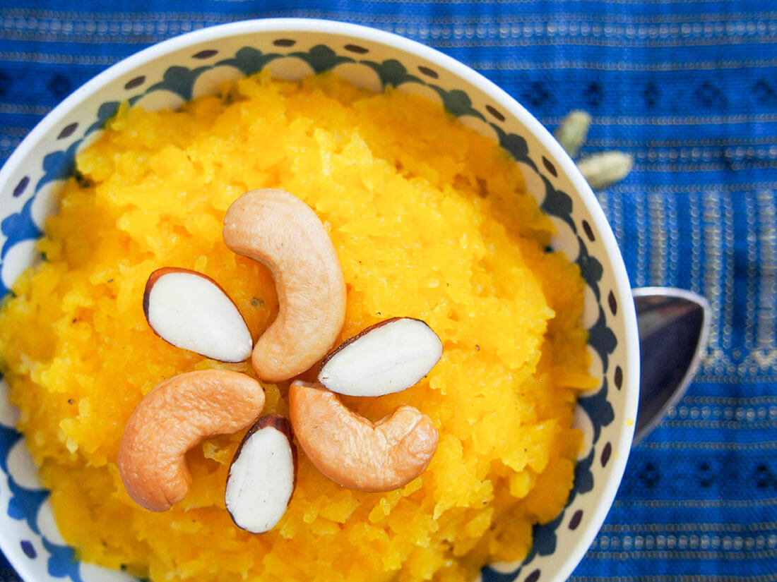 bowl of pumpkin halwa with nuts on top