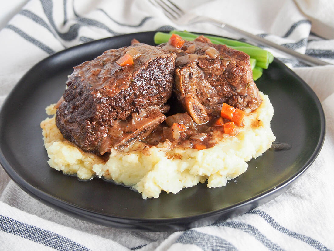 slow cooker short ribs served over mashed potato on plate