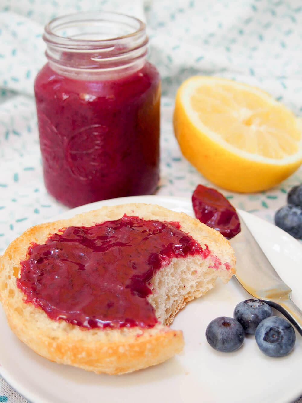 blueberry curd on bread with jar in background