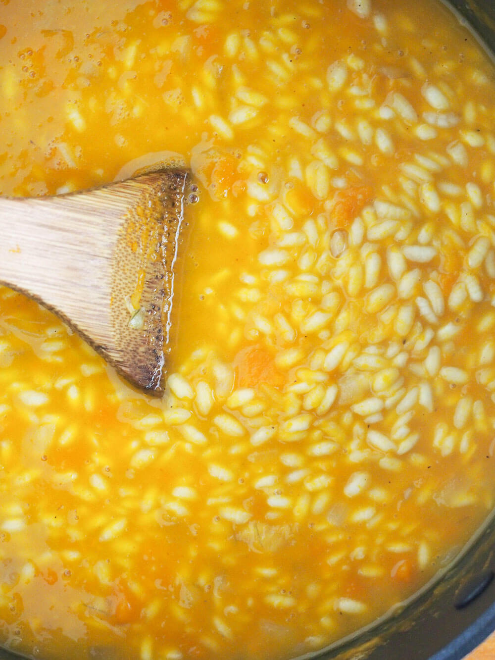 stock added to pumpkin risotto during cooking