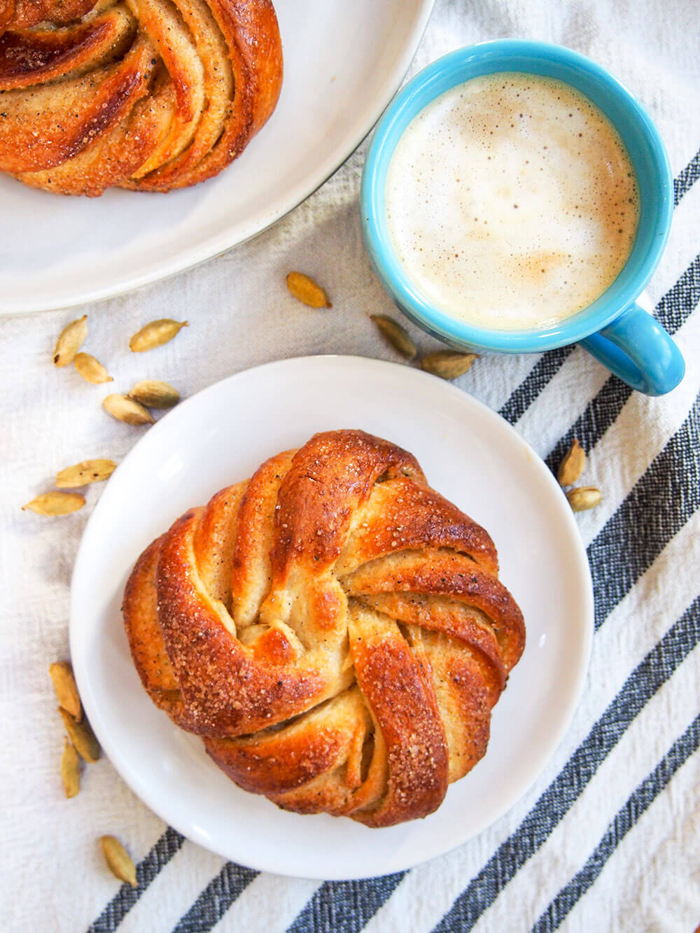 Swedish cardamom buns with cup of coffee to side from above