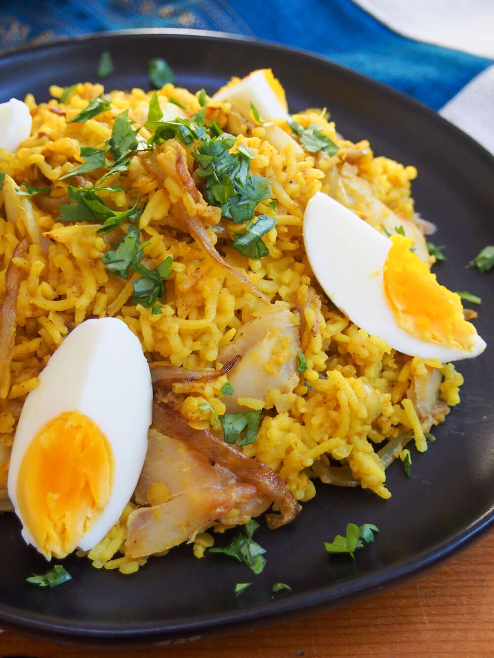 kedgeree on plate from side with slice of egg to front