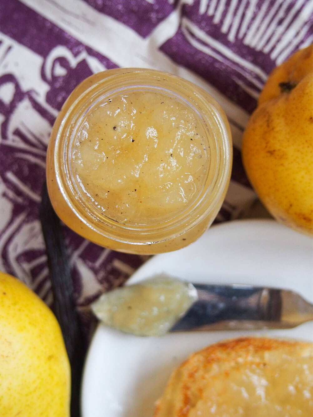 jar of pear jam from overhead with pear to side