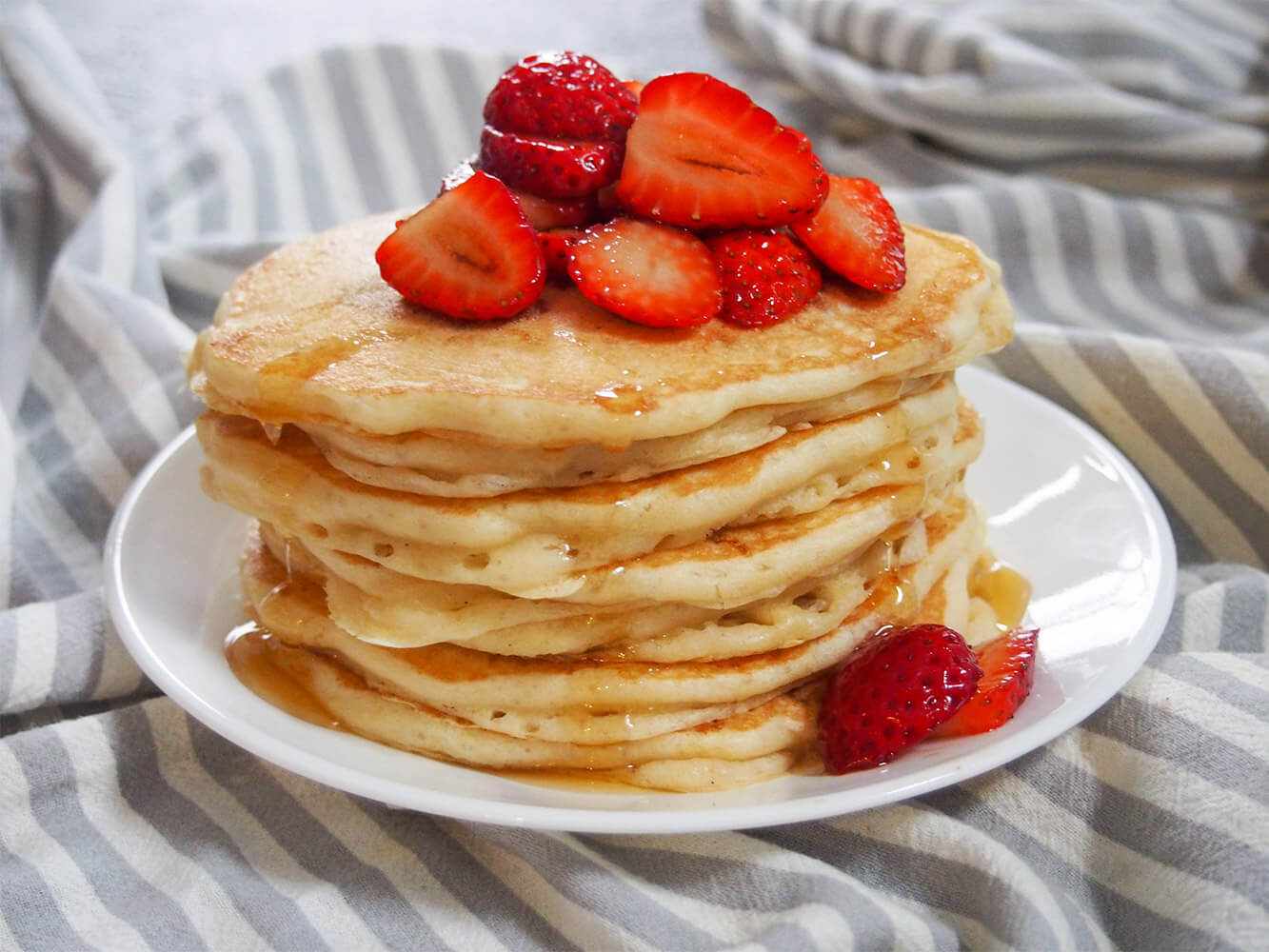 stack of sourdough pancakes with strawberries on top