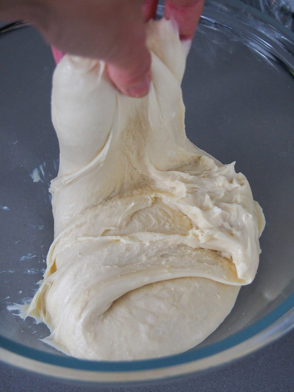 stretching and folding dough during first rising process