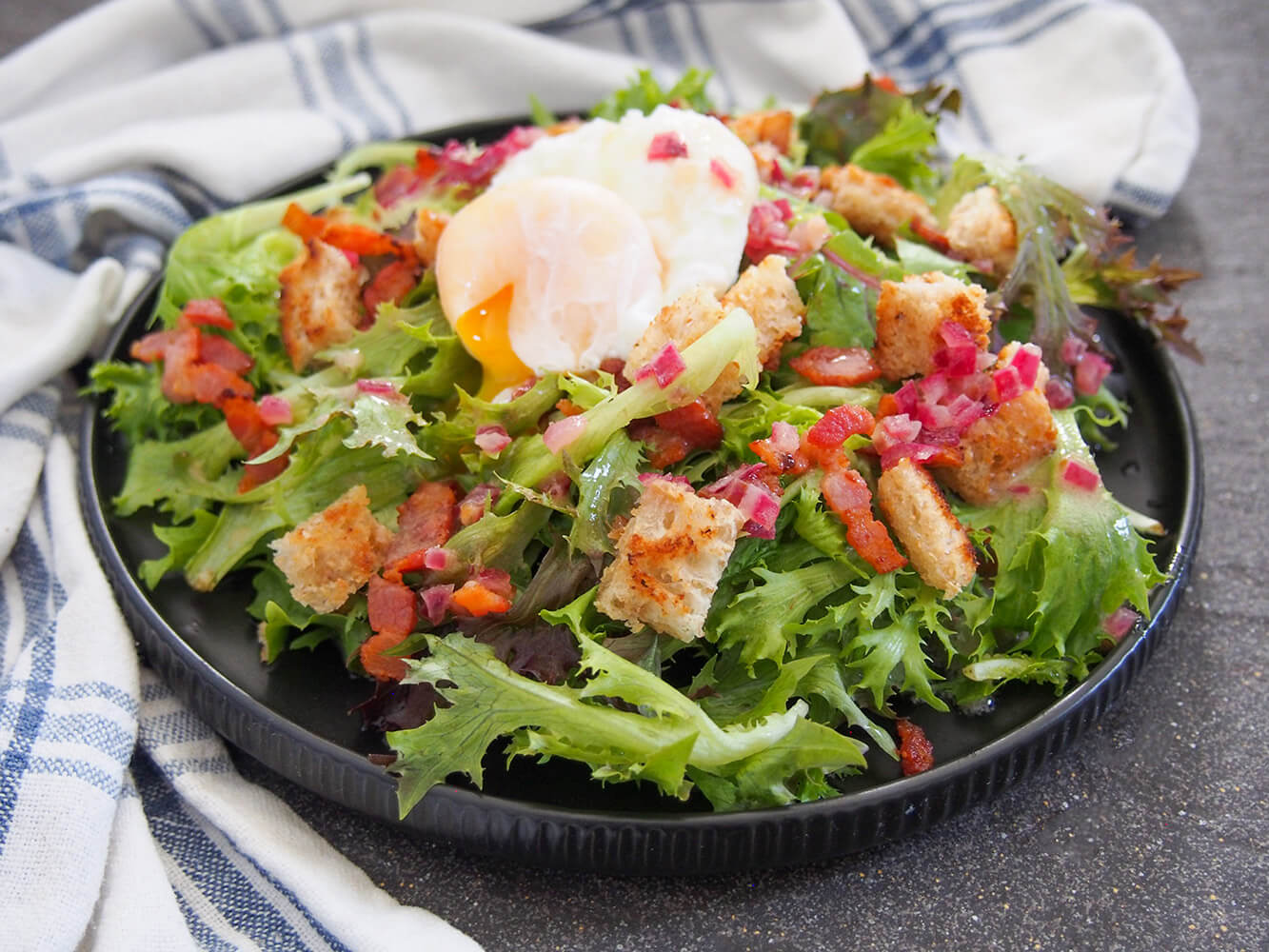 salade Lyonnaise - a simple green salad with bacon and egg on top