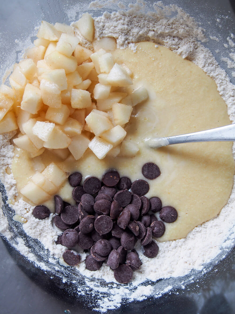 adding wet ingredients, pear and chocolate chips to dry ingredients