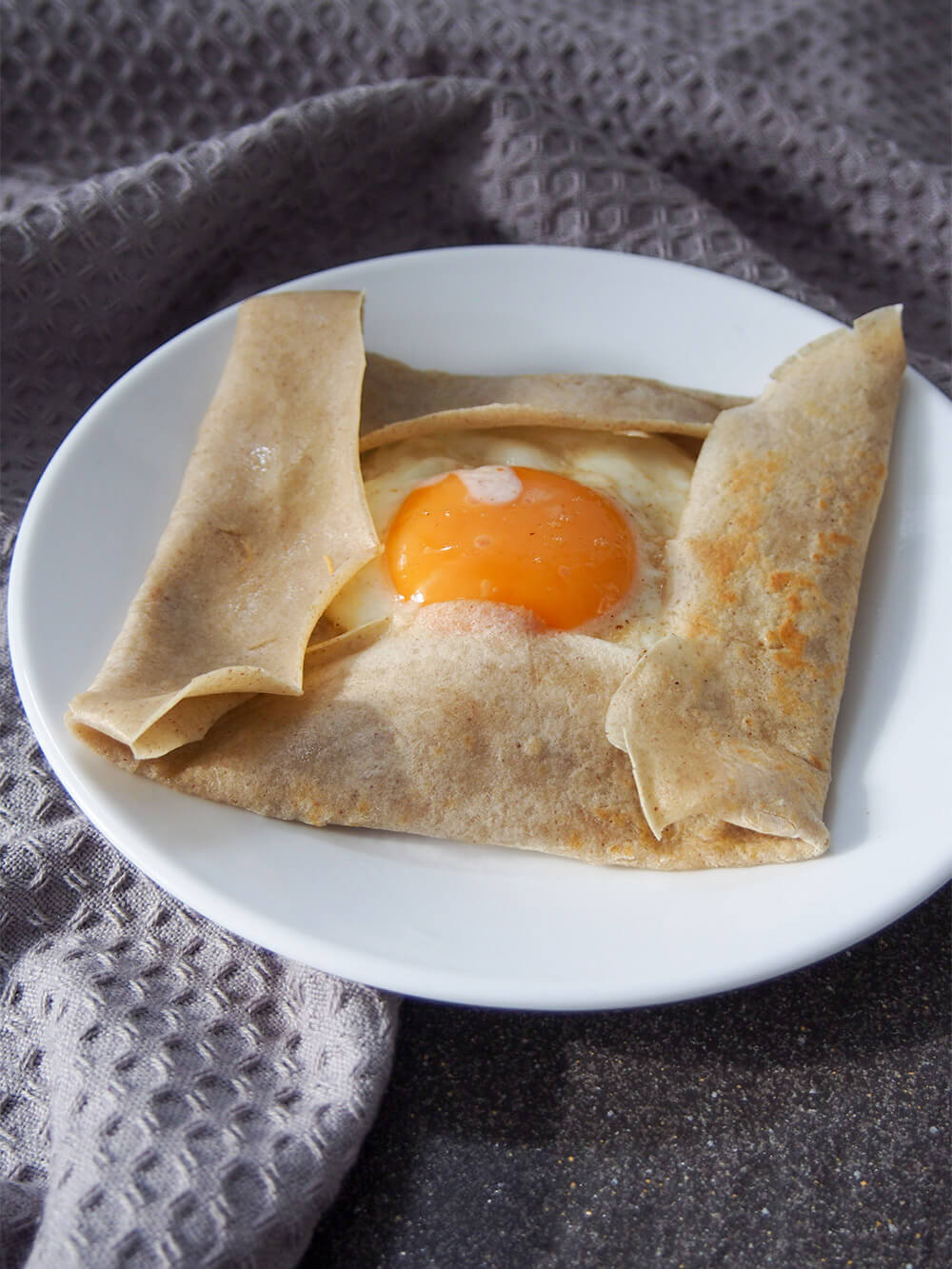 buckwheat crepe with fillings - egg showing - on plate