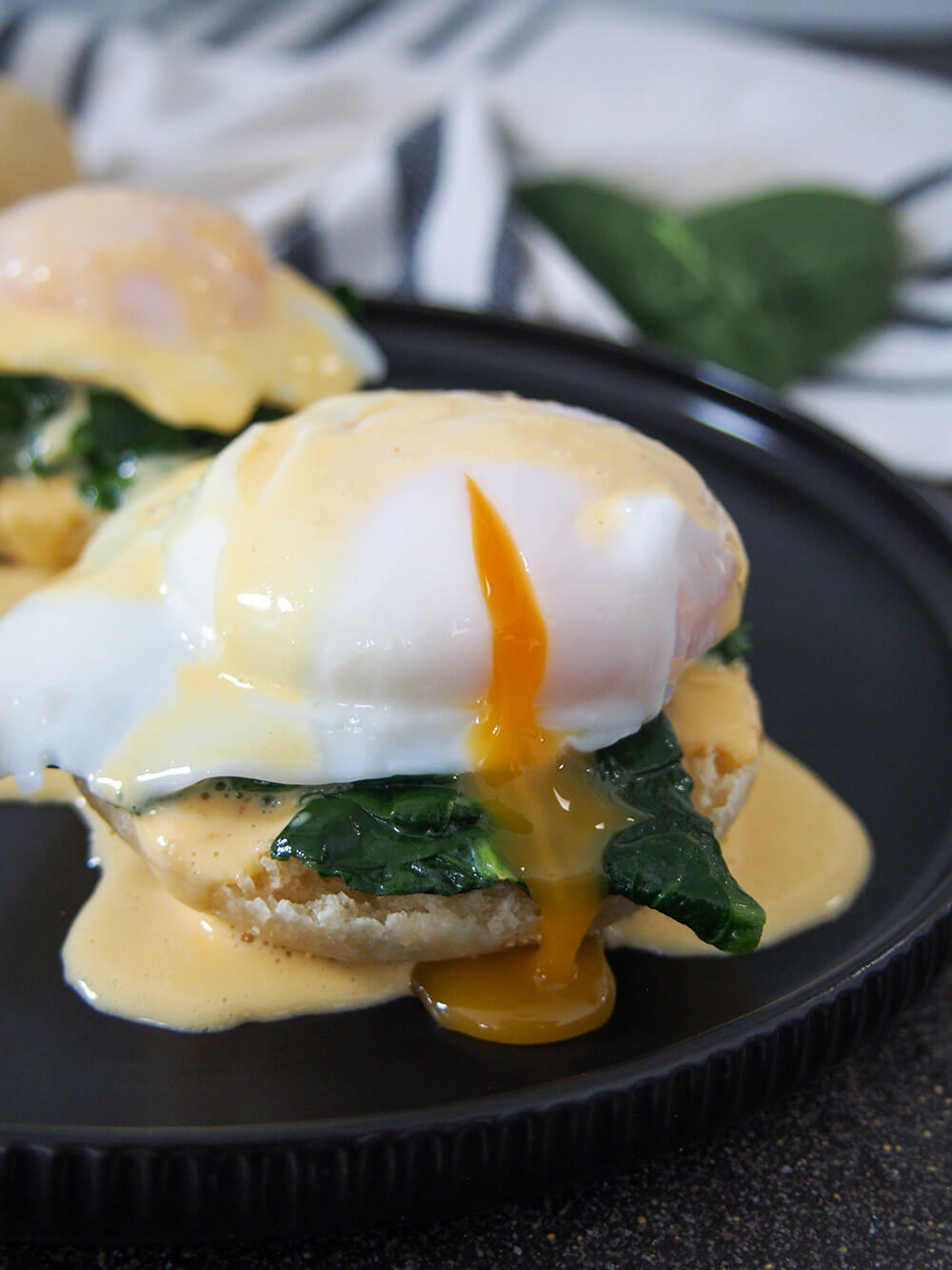 eggs Florentine with yolk of egg cut and oozing into rest