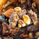 Beef bourguignon with spoonful over dish