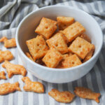 homemade cheese crackers in bowl with animal shapes ones below