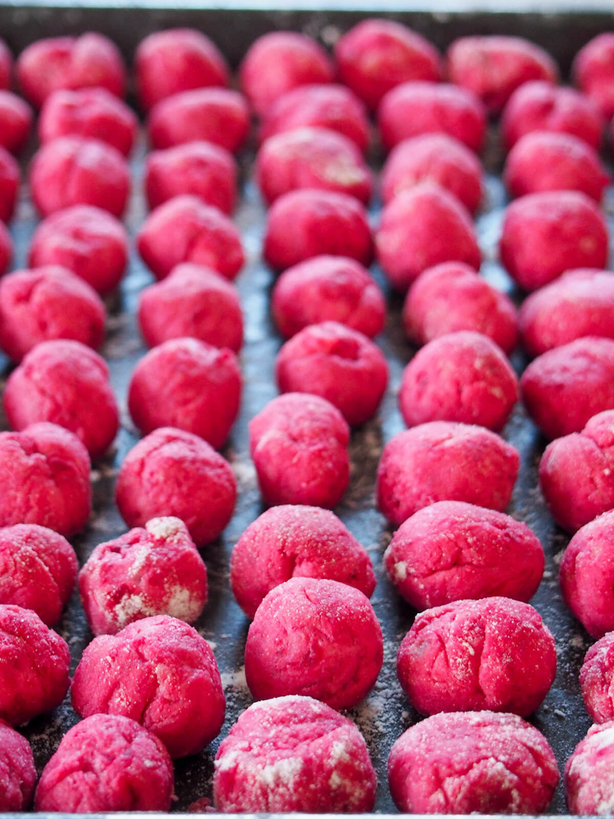 beet gnocchi formed and on baking sheet ready to cook