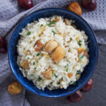 bowl of chestnut risotto topped with pieces of chestnut