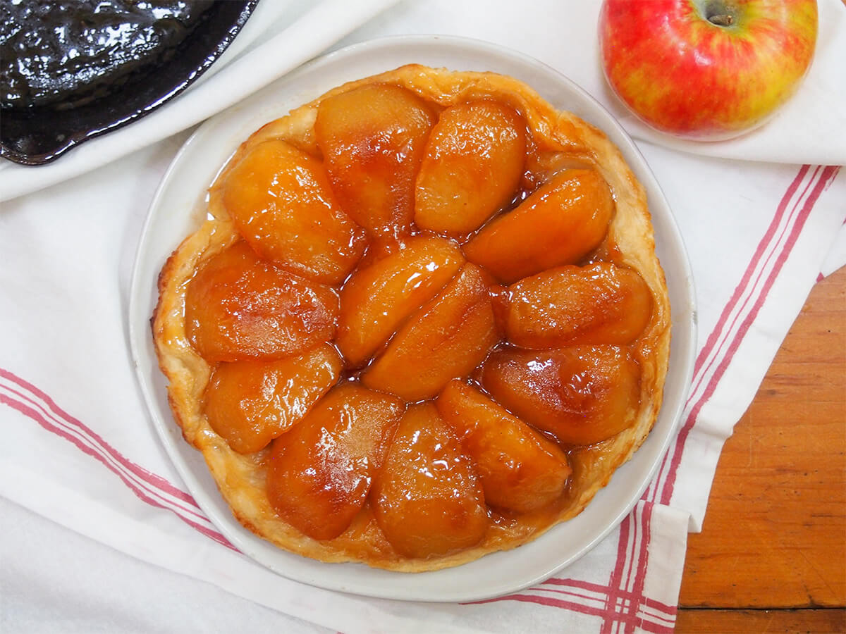 apple tarte tatin from overhead with part of whole apple showing above