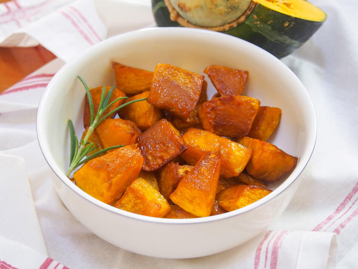 bowl of maple roasted buttercup squash with sprig of rosemary in side of bowl