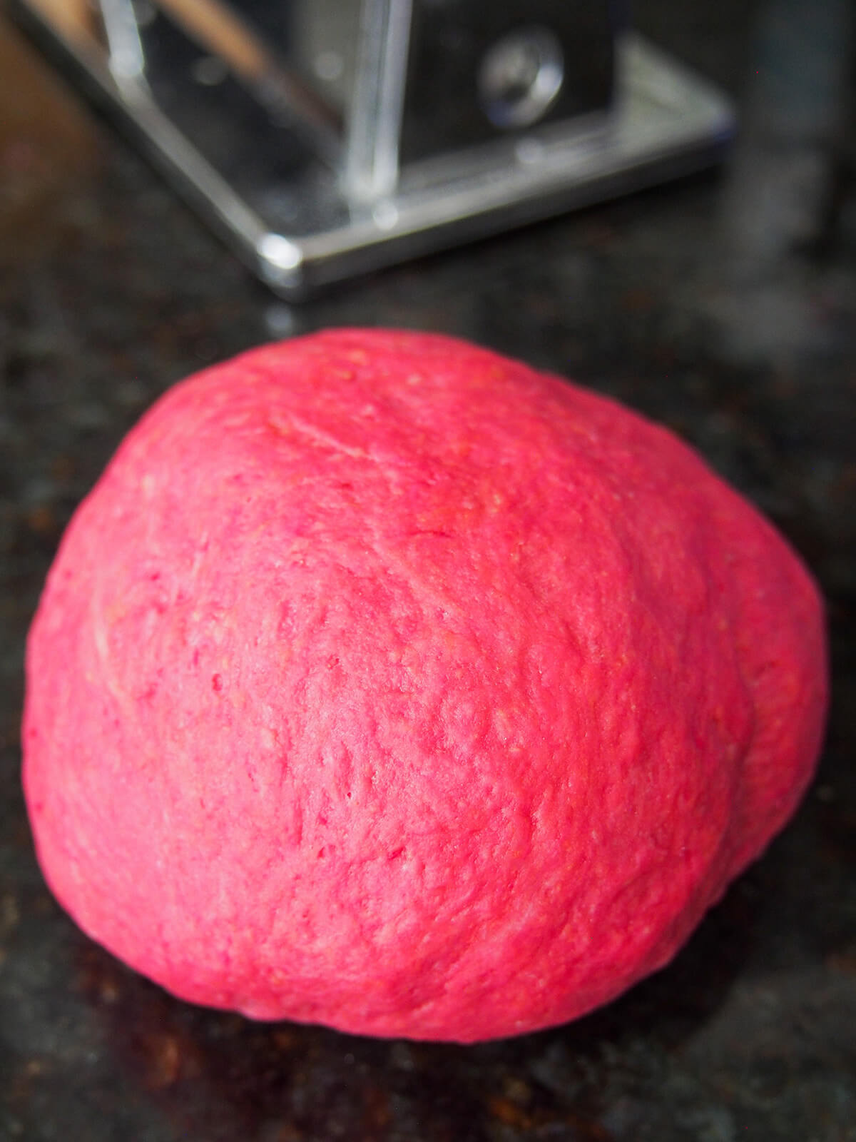 ball of beet pasta dough ball of beet pasta dough on work surface.