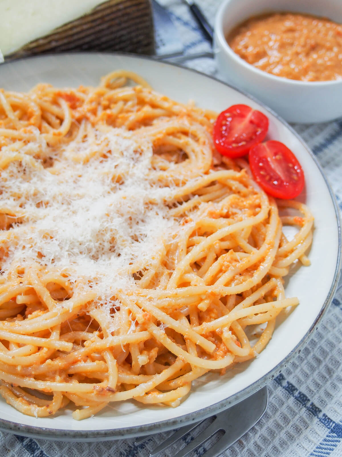 Romesco pasta is a super easy pasta dish that's perfect for any night. Spanish romesco sauce is packed with tasty flavor from tomato, nuts and more that wraps deliciously around the pasta. close side view of plate of romesco pasta.