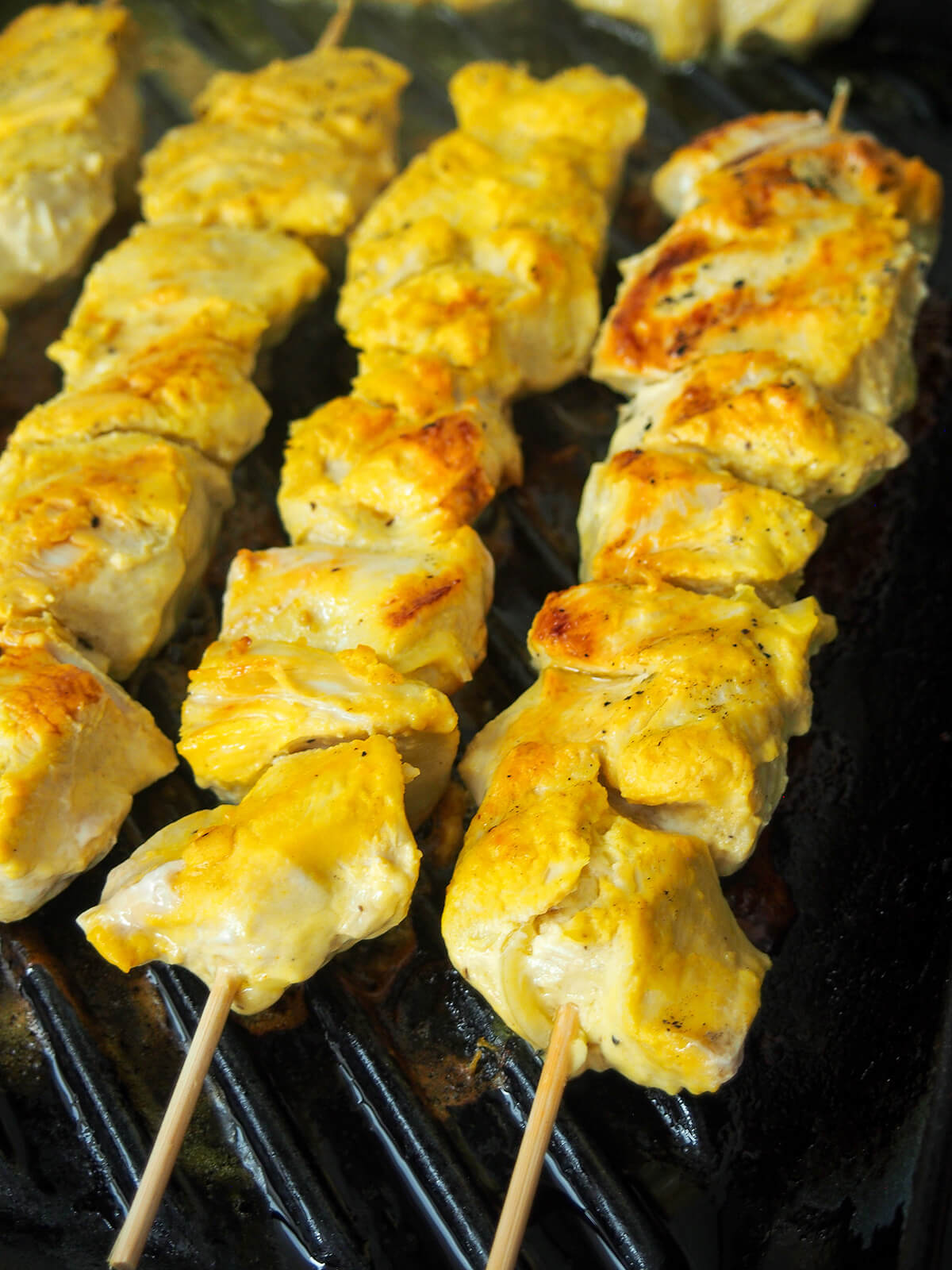coking joojeh kababs cooking skewers of jujeh kabab.