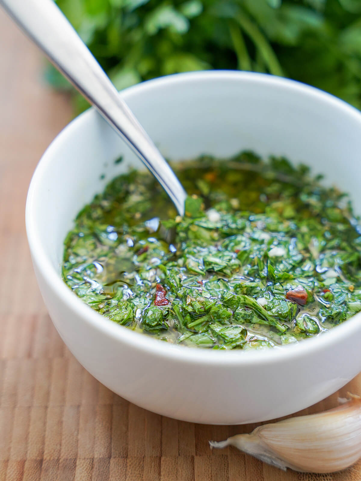 chimichurri sauce bowl of chimichurri sauce with spoon in it.