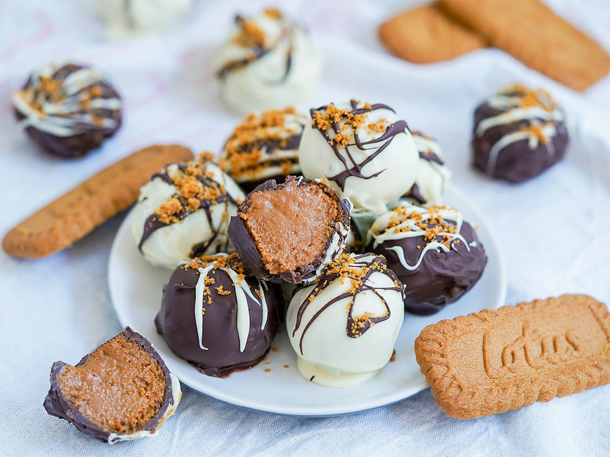plate of biscoff truffles plate of biscoff truffles with a cut half on top and half to one side with cookies to either side.
