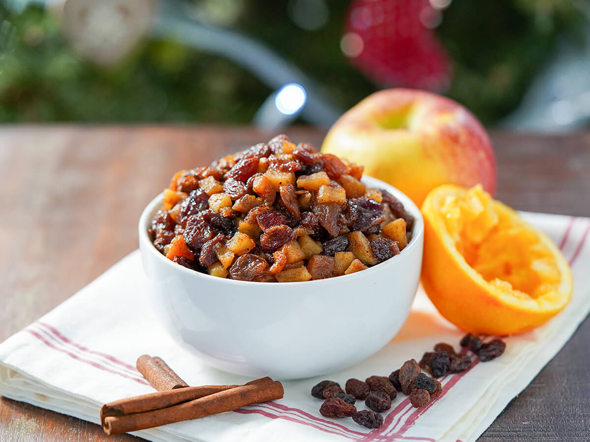 bowl of sugar free mincemeat with apple and squeezed orange to side.