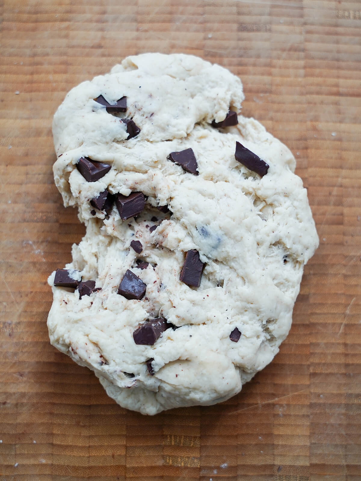 adding chunks of chocolate into dough.