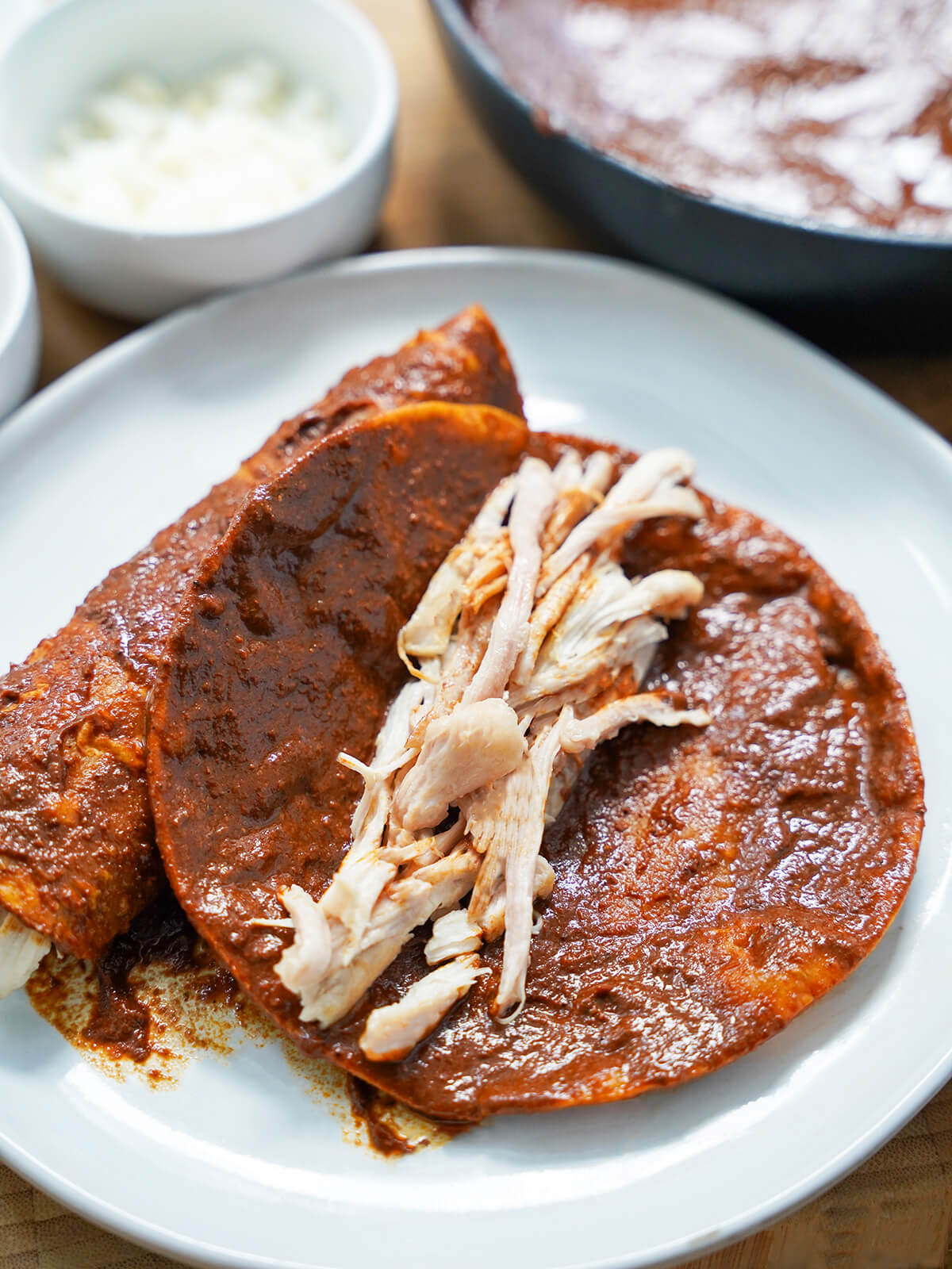shredded chicken on top of a mole-dipped tortilla before folding.