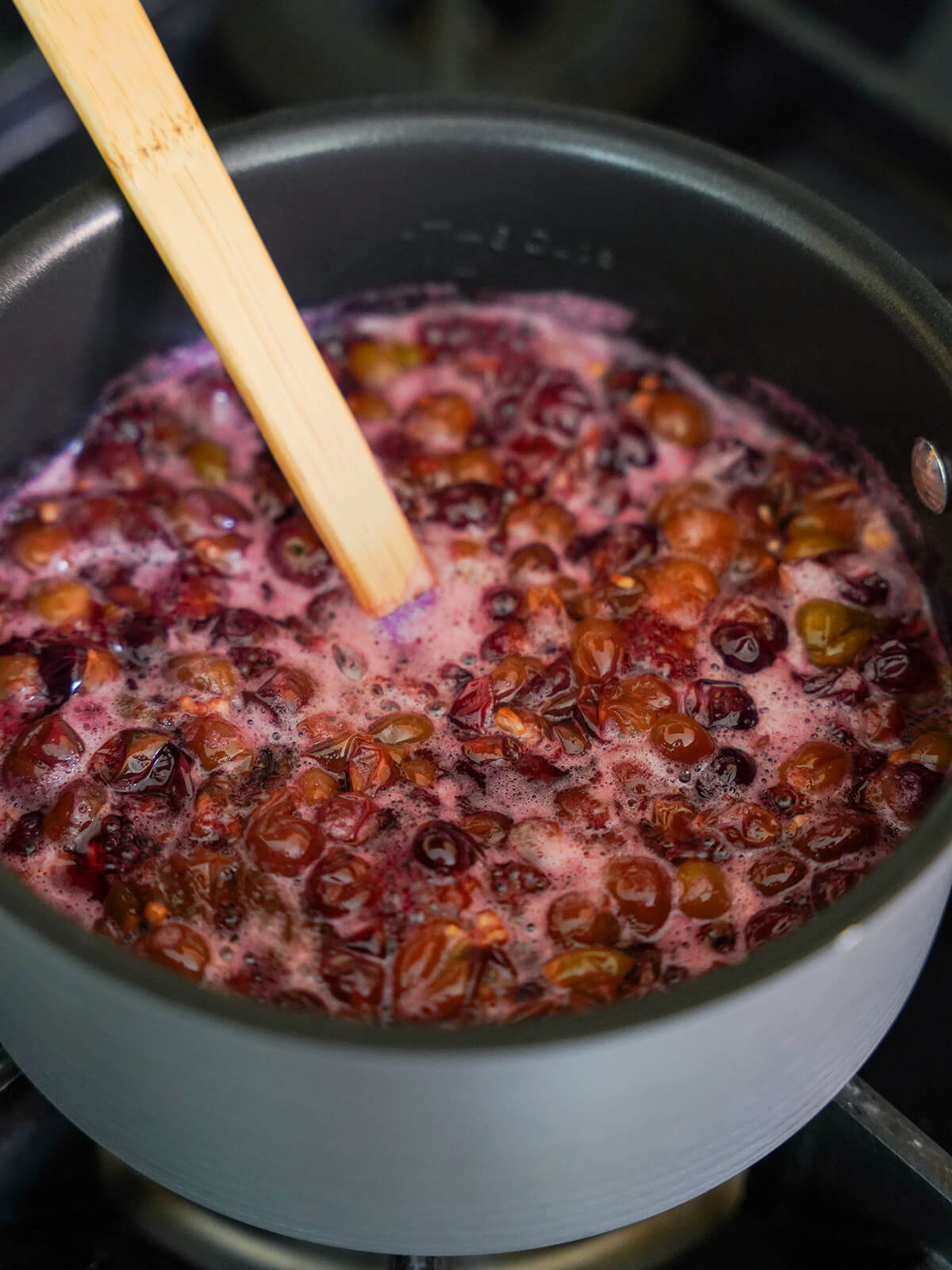 cooking grape mixture in pan to make syrup.