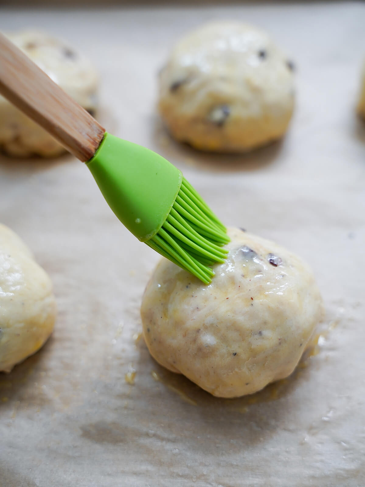 brushing buns with eggwash as they are on parchment lined baking sheet.