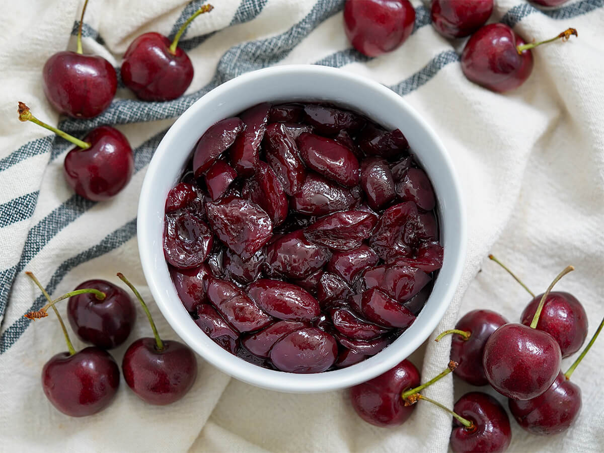 bowl of cherry compote bowl of cherry compote with cherries either side.