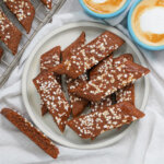 overhead view of plate of chokladsnittar, Swedish chocolate cookies with pearl sugar decoration on top.