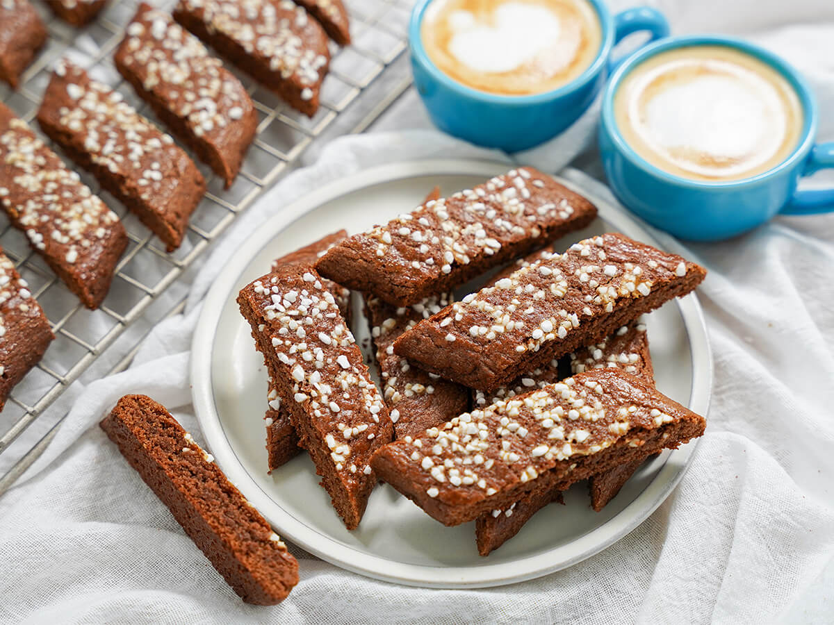 plate of chokladsnittar, Swedish chocolate cookie slices side view of chokladsnittar, Swedish chocolate cookies stacked on a plate.