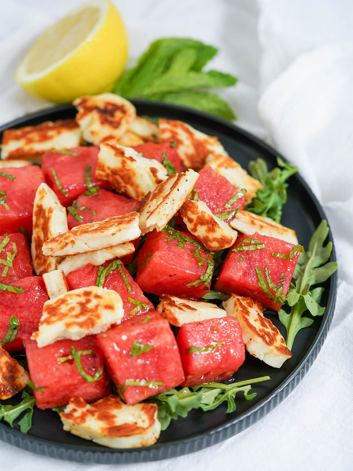part view of plate of halloumi and watermelon salad.