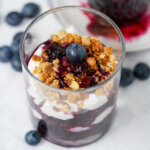 close up overhead view of glass of blueberry parfait.