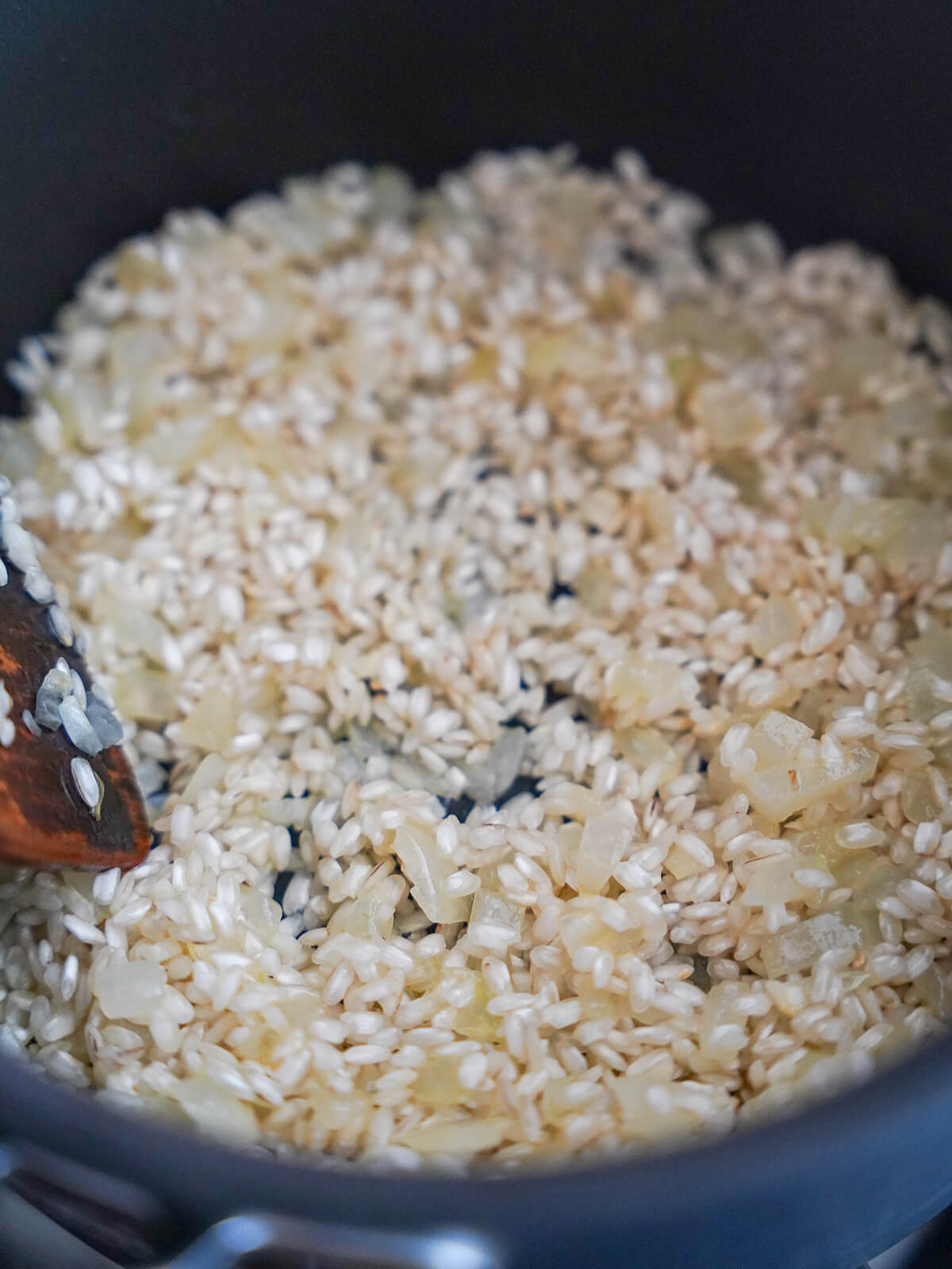 softened onions and rice in pot.