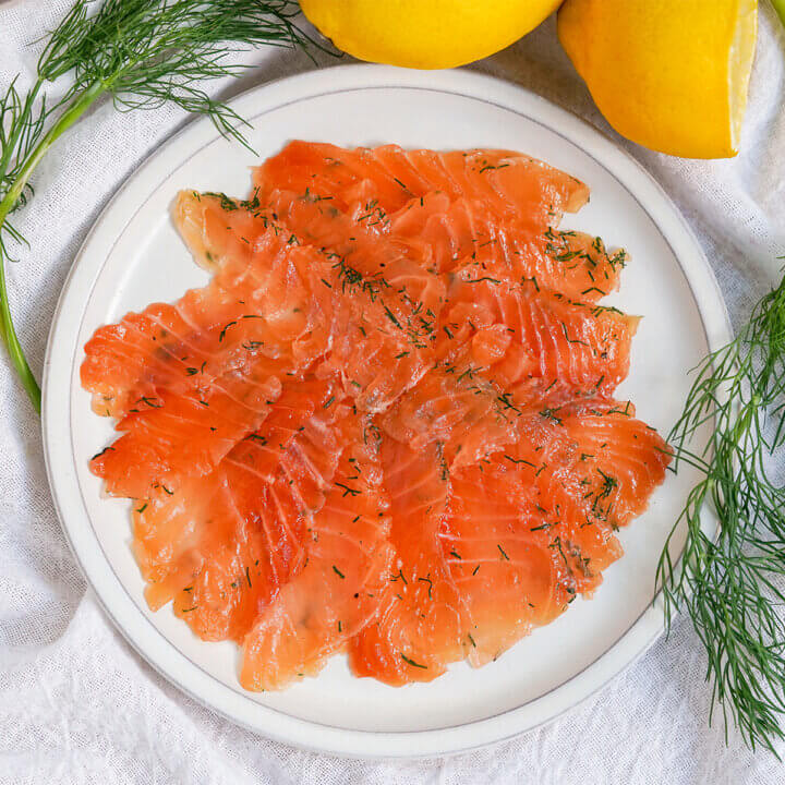 slices of salmon gravlax on a plate.