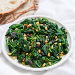 small plate of Catalan spinach with pine nuts and raisins.