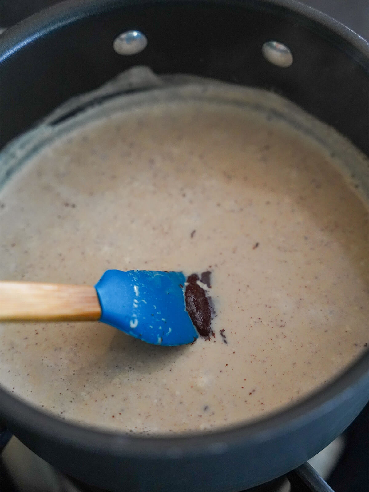 stirring milk mixture and melting chocolate into it.