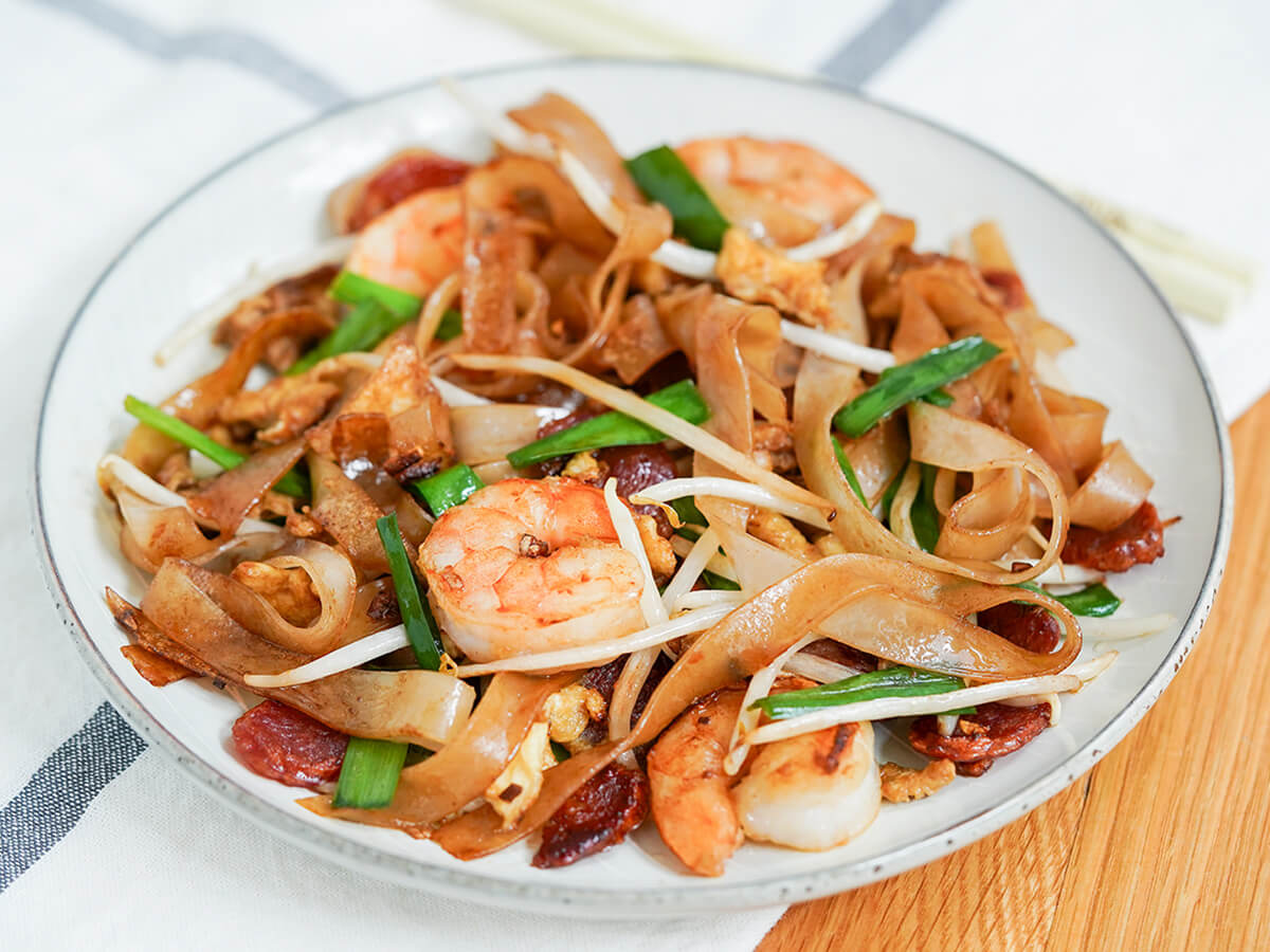 side view of plate of char kway teow noodles.