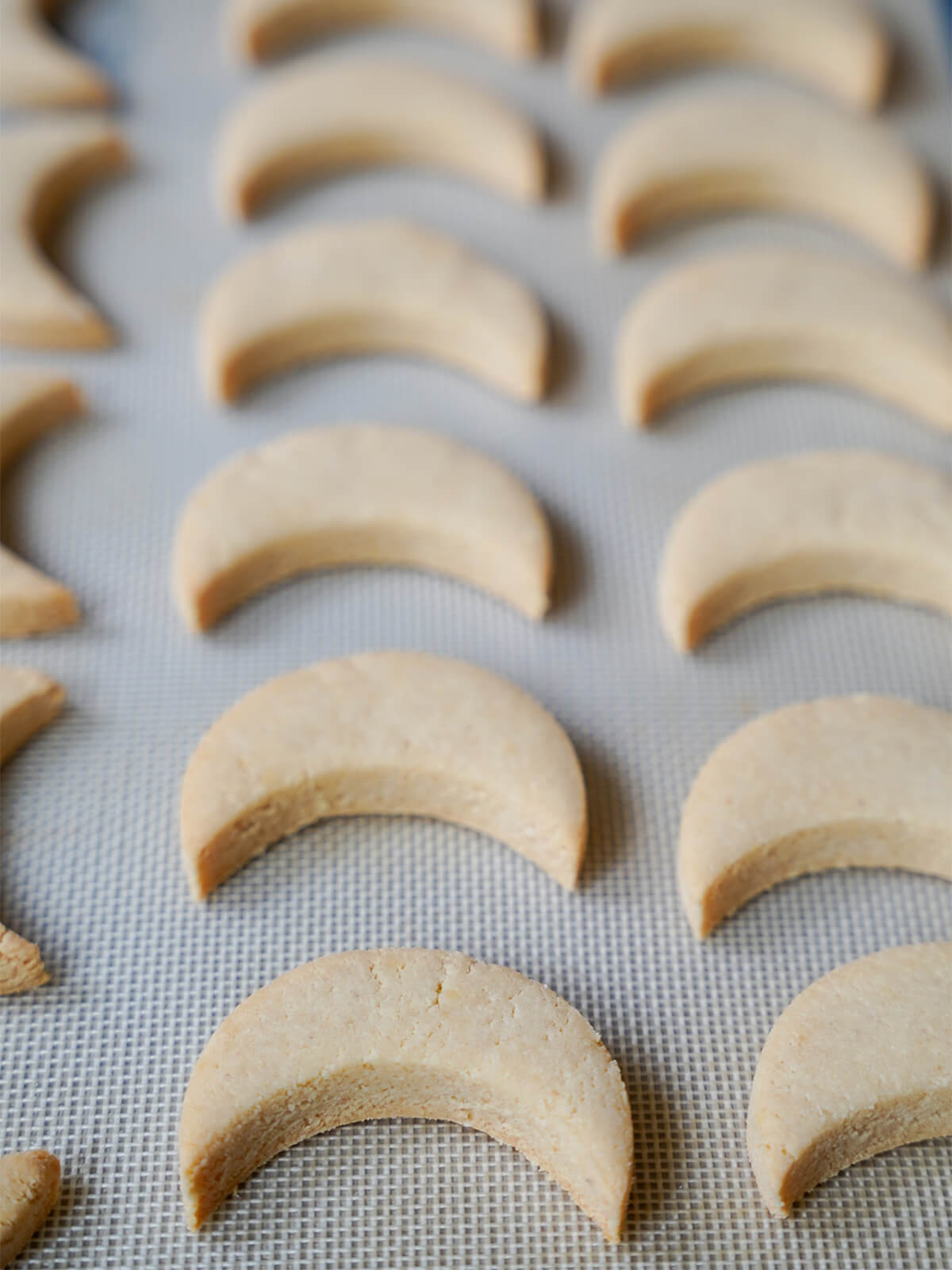 lemon almond cookies zedernbrot out oven before adding glaze. lemon almond cookies zedernbrot out oven on baking sheet before adding glaze.